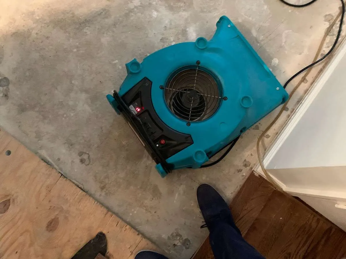 Air mover drying subfloor during Commercial Water Damage Restoration in West Valley City